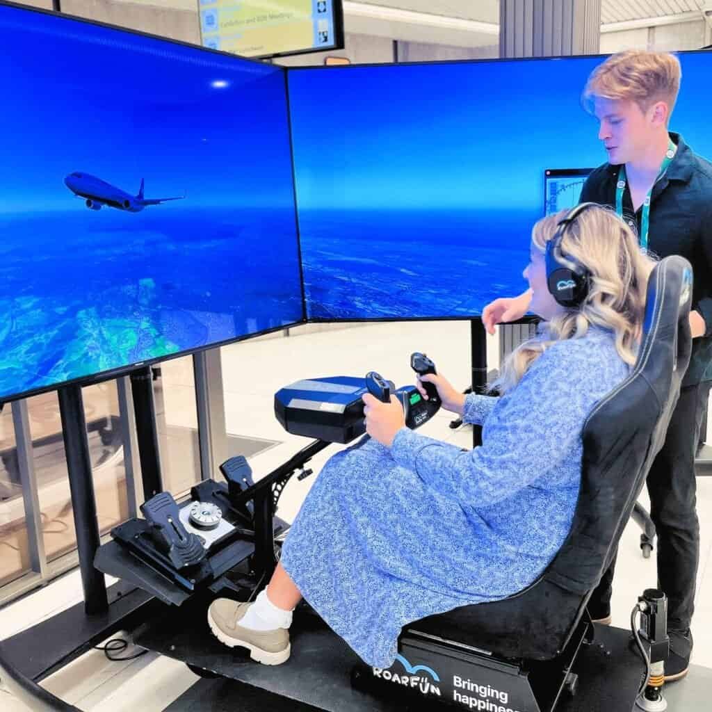 Happy lady with a travelling flight simulator.
