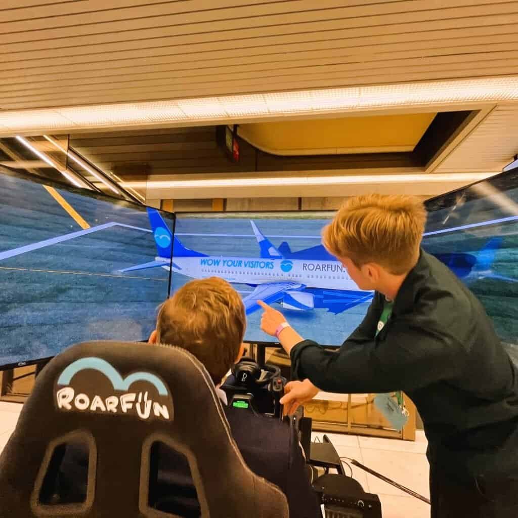 RoarFun Support shows branding on a flight simulator.