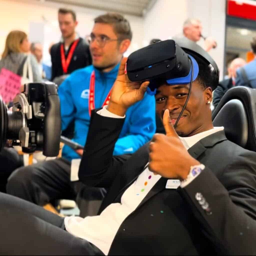 Happy person on VR Formula simulator hire in Munich Messe, Germany.
