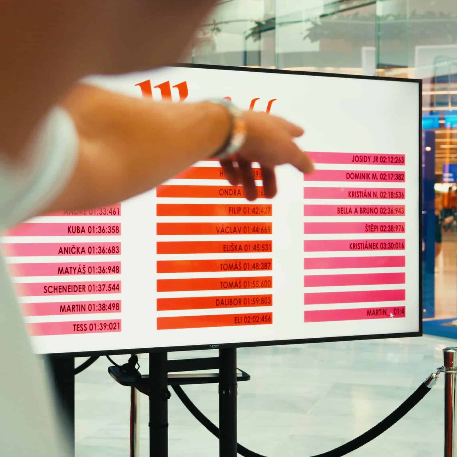 Man points to a competition table designed by roarfun for shoping mall brand activation.
